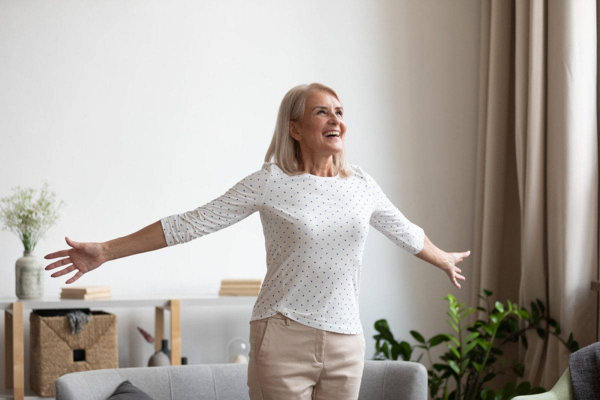 Smiling older woman feeling thankful for good day.