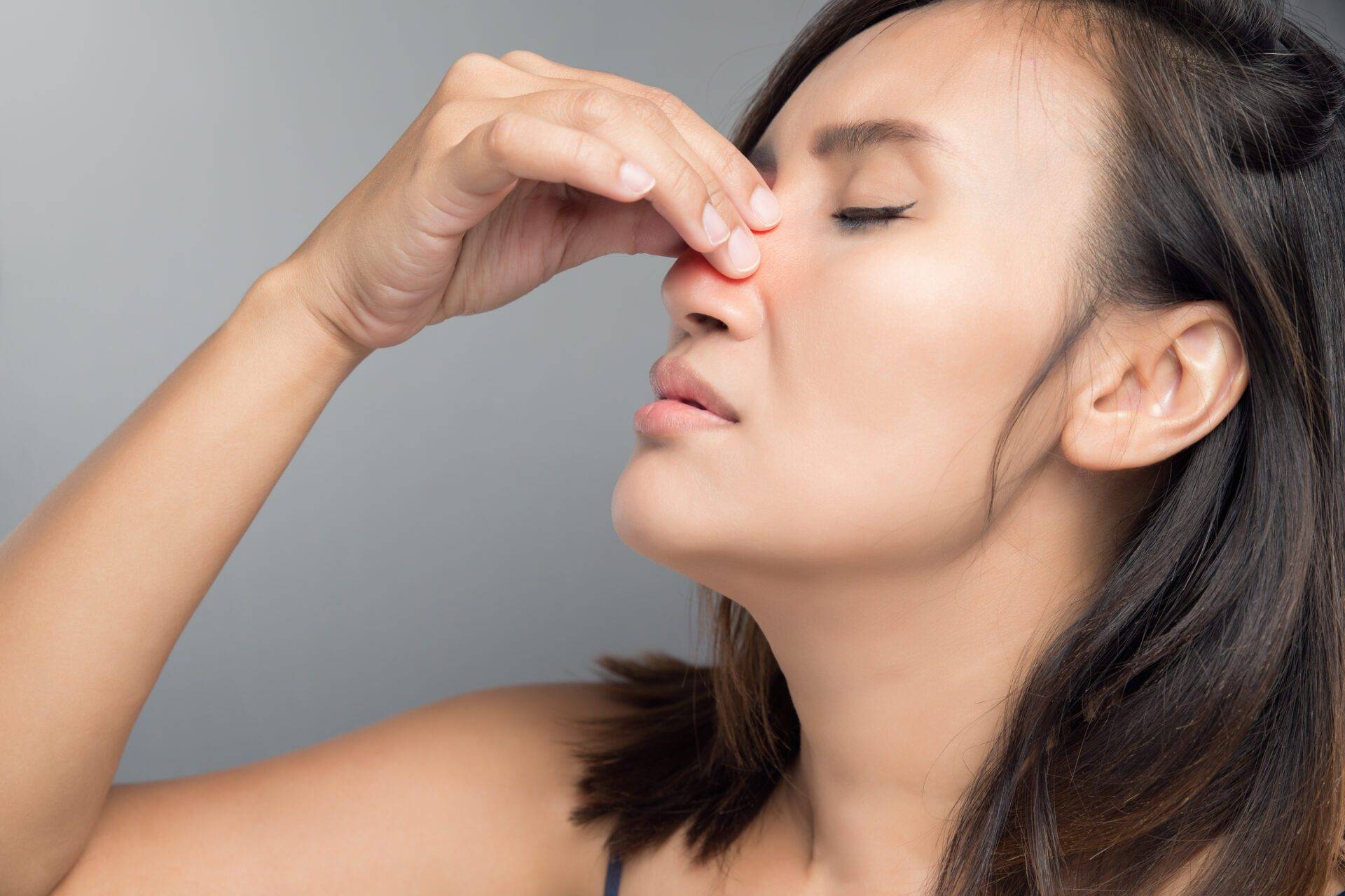 The asian woman hurts her nose because she has cold.