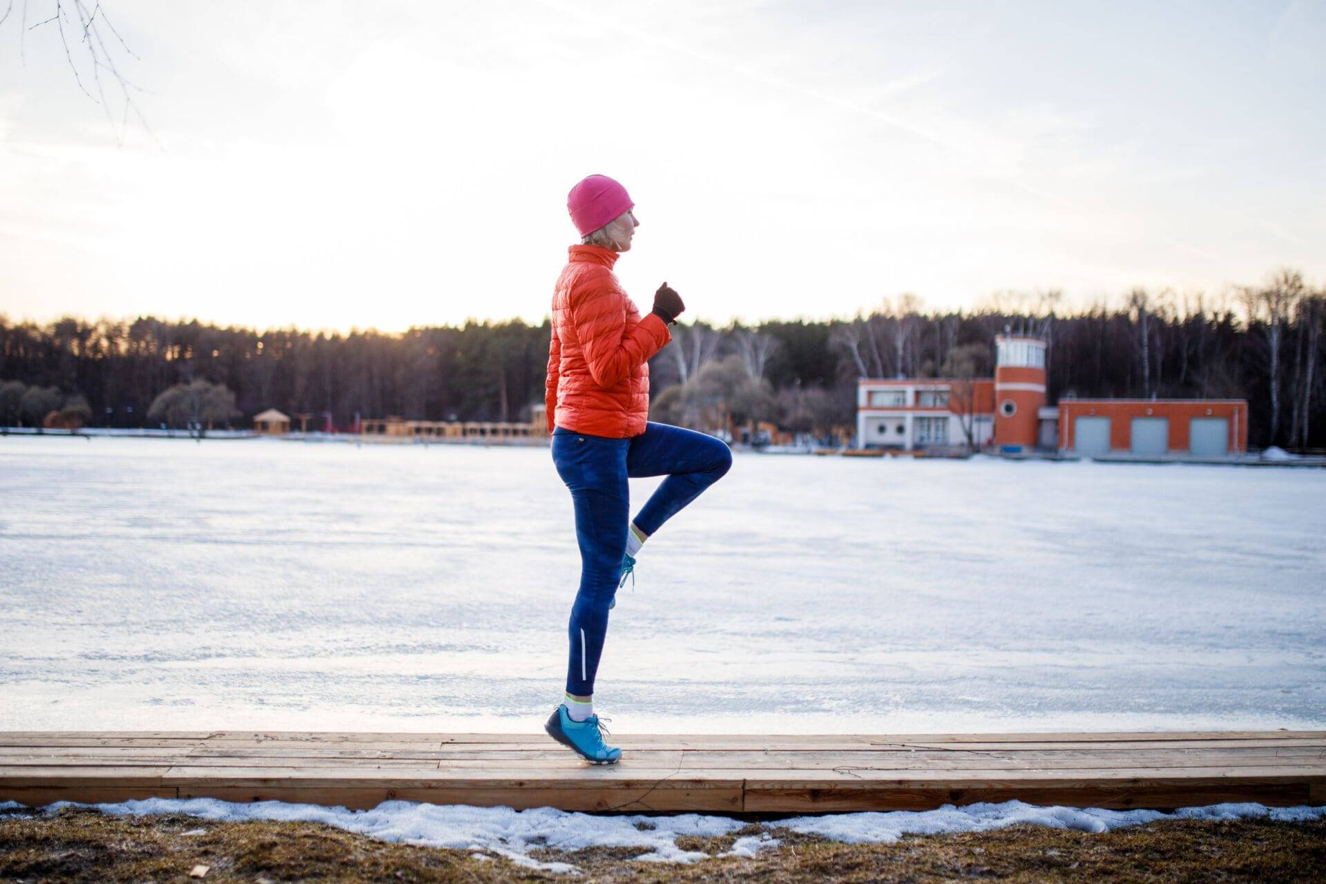 a woman is running on a trail in the sun